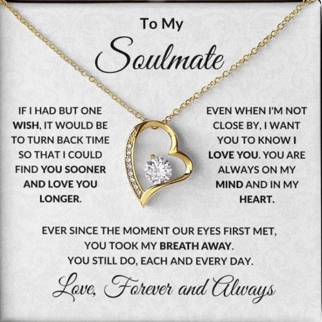 Heart-shaped gold necklace with a sentimental message card on a white background